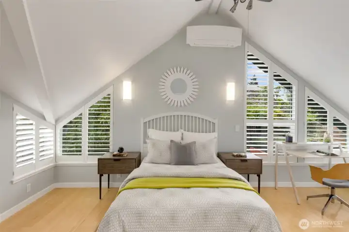 Third floor bedroom with plenty of space for seating or office set up. This bedroom looks west over the backyard and decks.