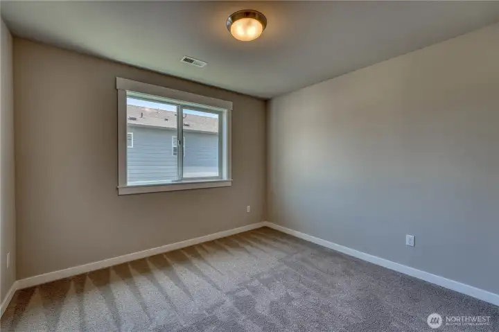 One of two additional upper level bedrooms