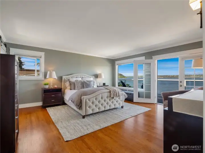 The primary bedroom on the main floor has an amazing view to wake up to. Enjoy your morning coffee on the deck right outside the French doors.