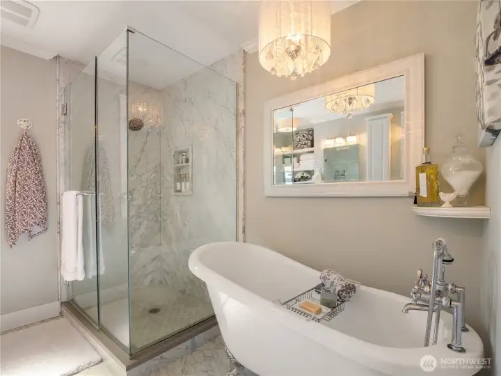 The primary en suite is a glamorous place to take a nice soak in the claw foot tub. The crystal chandelier adds that little extra. The Marble surround walk in shower is also a touch of luxury. Pamper yourself and relax!
