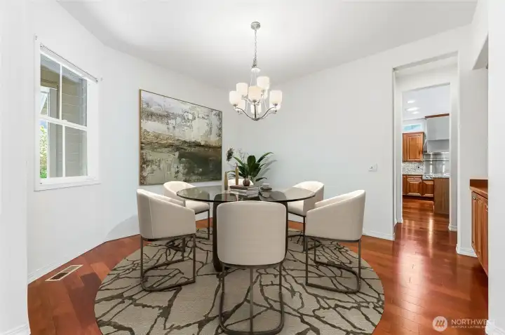 Formal dining room with a butler's pantry connecting it to the kitchen. Virtually staged.