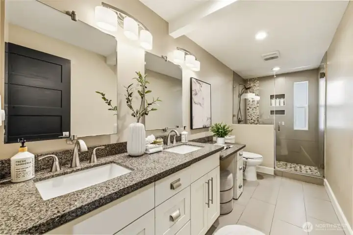 The hall bathroom downstairs includes a large shower and dual sinks