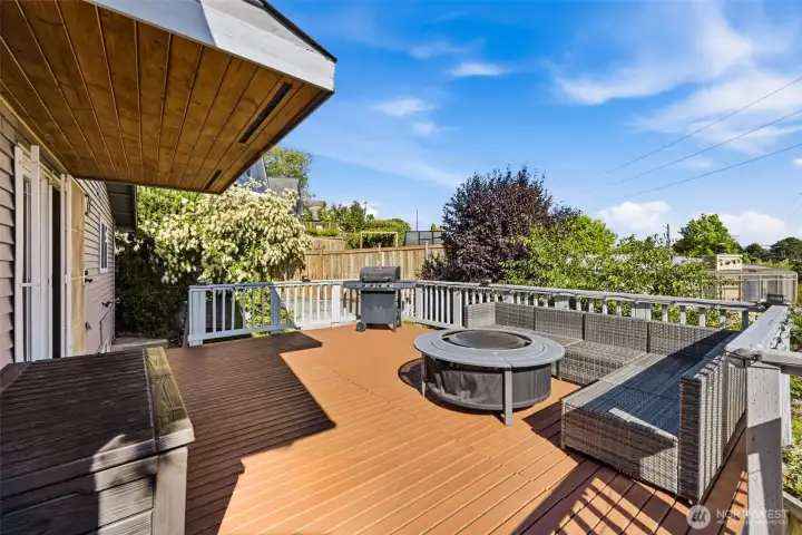 The main deck off of the kitchen is the perfect gathering spot to soak up sunny days and enjoy an evening fire