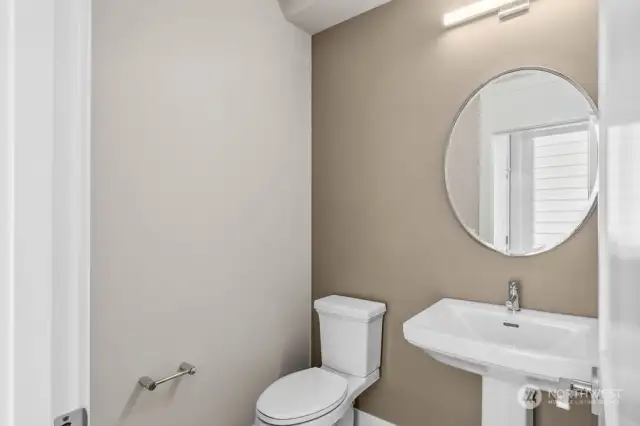 Main floor powder bathroom with pedestal sink.