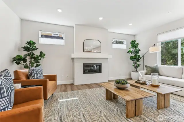 Huge great room with large windows, LVP Flooring throughout main level, cool textured tile surround gas fireplace, Smurf tube ready for TV/Cable.  Perfect for large gatherings or snuggle up around the fireplace for a nice read or to watch TV.