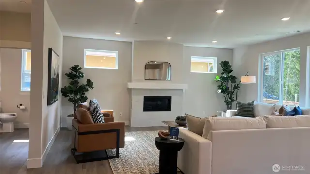 Oversized great room, perfect for large gatherings.  Plentiful number of large windows for that wonderful added natural lighting.  Gas fireplace and textured tiled surround.  Powder bath on main with cabinet/sink.