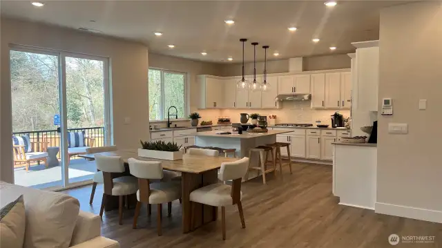 Nook area for that added seating and ideal for those large get togethers.  Large island with pop up outlet.  Quartz Counters, GE Cafe SS appliances including refrigerator, 5 burner gas cooktop, in-wall microwave and oven.  Gorgeous soft-close Huntwood cabinets/drawers and black hardware throughout.  Modern pendant lights and upgraded faucet.