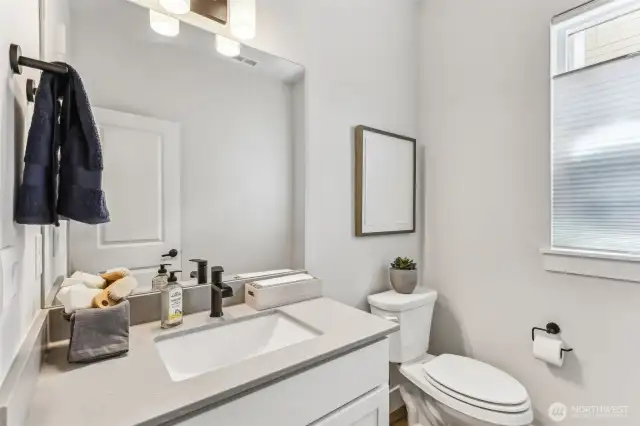 1/2 bath w/quartz counter on main level.
