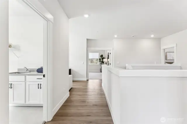 Upstairs hall with laundry room, sink and qtz countertop.