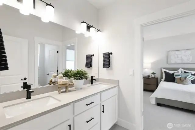 Upstairs bath with separate area for the tub/shower/toilet.  Dual sinks, qtz countertops, tile floor and black hardware throughout.
