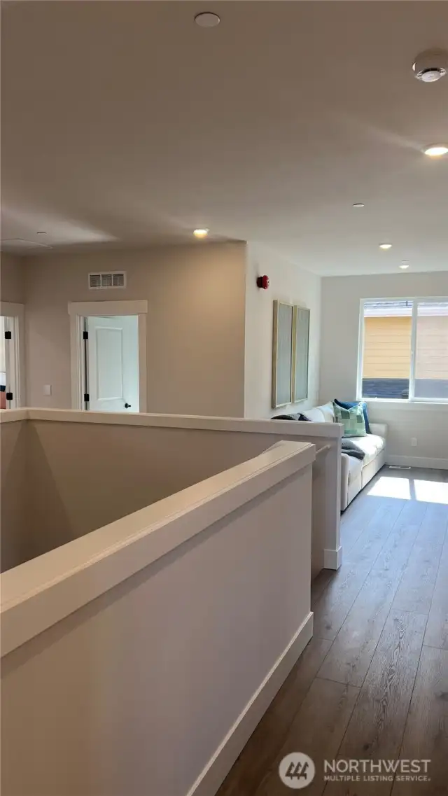 Upstairs hall and a look into the loft room.