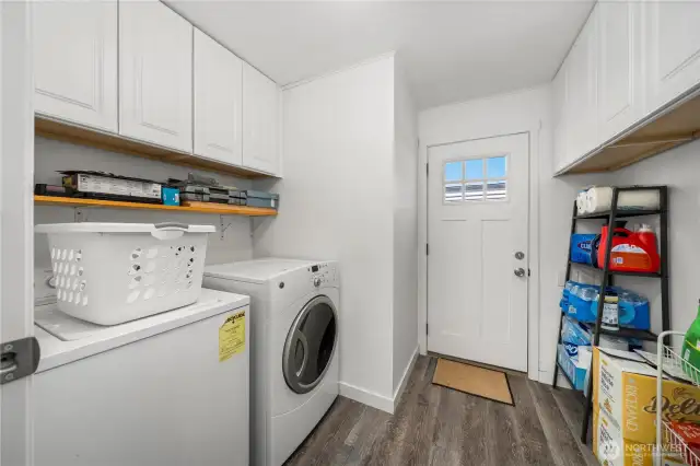 Good sized laundry room with lots of storage.