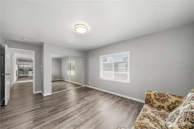 Primary bedroom with all glass closet doors..