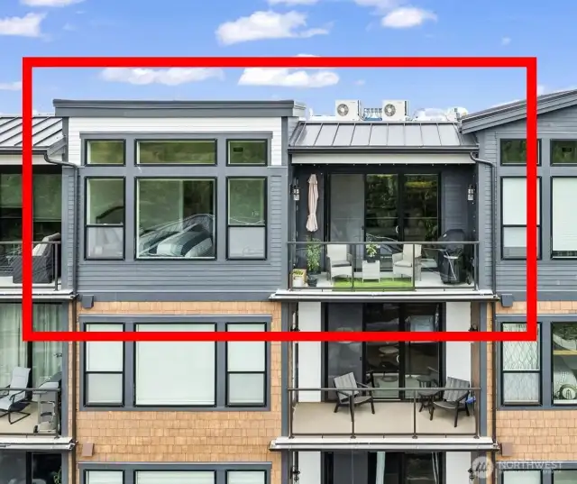 Private deck with no neighbors upstairs! The primary bedroom has transom windows that allow the natural light to flood in.