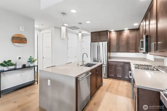 Chef's kitchen with gleaming stainless Bosch appliances and gas cooktop. Abundant cabinet storage.