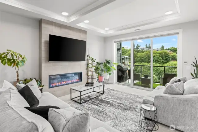 Spacious living/great room with a coffered ceiling detail and access to your deck.