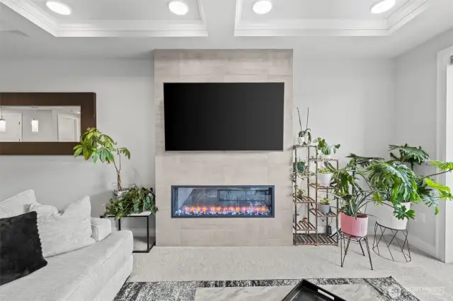 Cozy electric fireplace with floor-to-ceiling tile surround. Wired for your tv...the mount stays