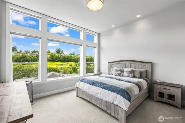 Spacious primary suite with huge windows to capture the hillside views.