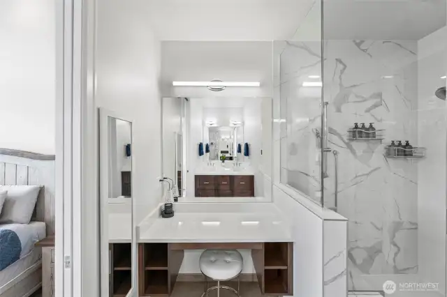 Separate vanity space in the primary bathroom. It has its own lighting and nice storage.