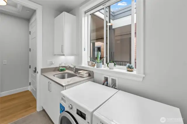 Separate laundry room with sink & storage - washer & dryer included.