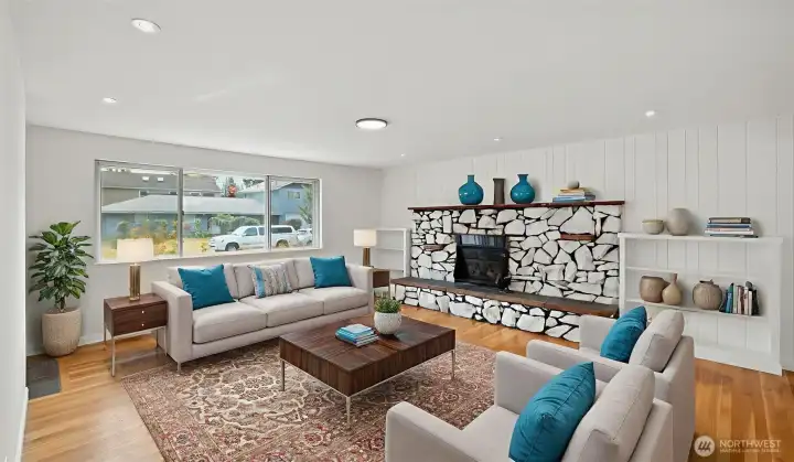 Living room with recessed lighting and big picture window for abundant sunlight. Virtually staged.