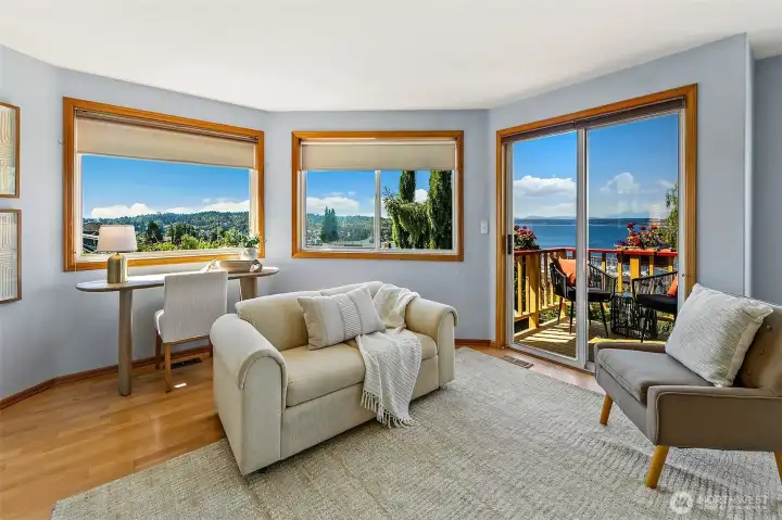 Primary bedroom has sweeping views and space for both a king bed and separate seating area.