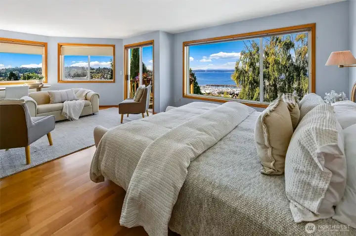 Primary bedroom has sweeping views and space for both a king bed and separate seating area.