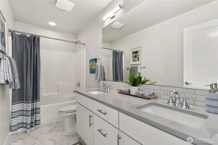 Picture of a similar home. Secondary bath, two undermounted vanity sinks + tub/shower.