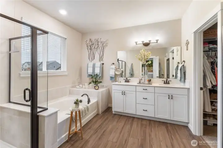 5 piece primary bath with tile, glass enclosed shower and large soaking tub. quartz counters and large closet.