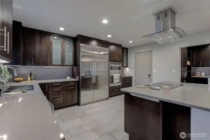 Oversized fridge and generous cabinets and counter space.  A peek into the walk in pantry