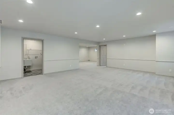 Laundry with utility sink, 4th bed to the right and more living space ahead