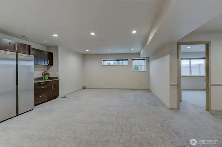 Lower living w wet bar & a peek at right to the 4th bedroom - Fiber high speed Cable in this home