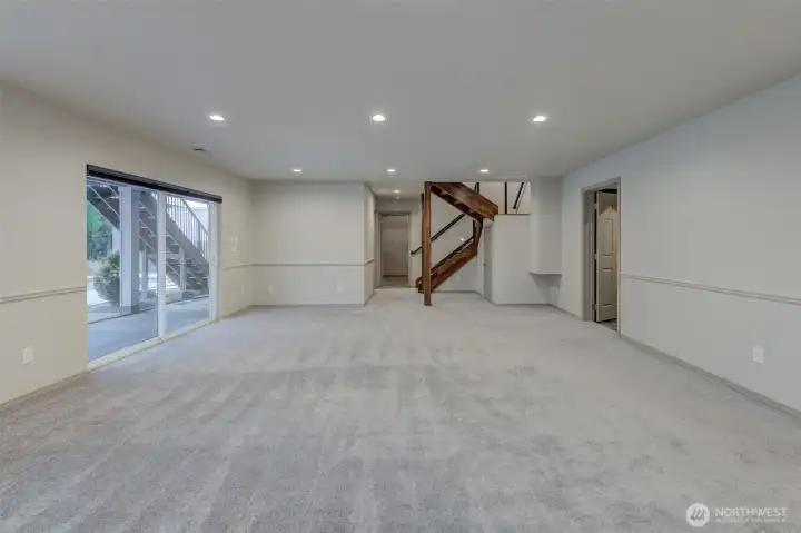 Looking back to the elegant staircase.  Large slider leads to lower gathering space and your built in pool area!