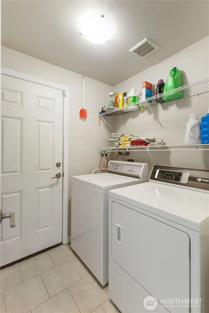 Utility room with Speed Queen W/D just inside entry from garage.