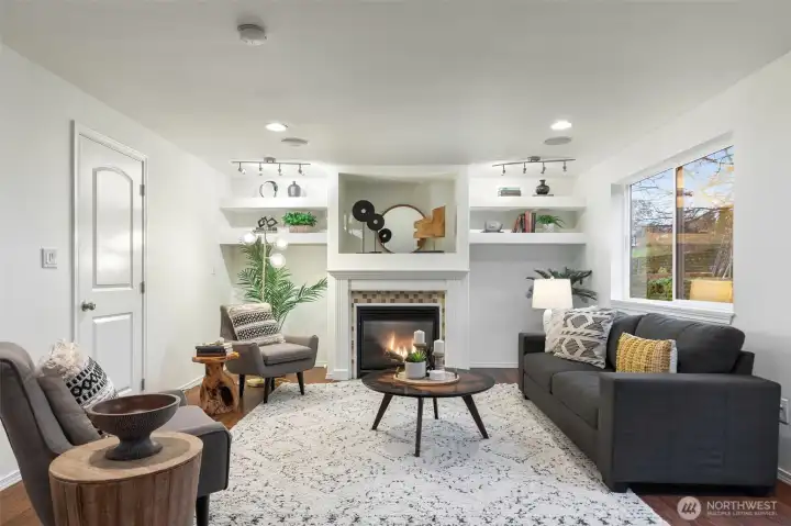 A second living room off the kitchen is anchored by a cozy, gas fireplace.