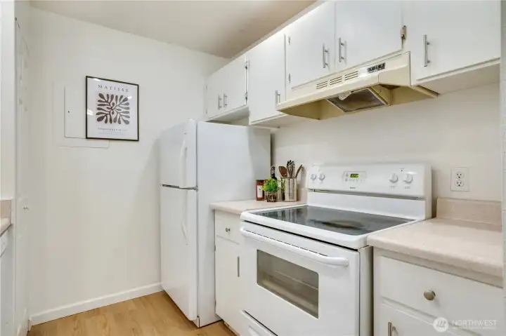 Galley kitchen with included appliances and efficient layout.