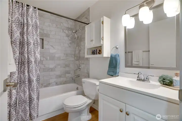 Full bath with a new low-maintenance shower surround (2025).