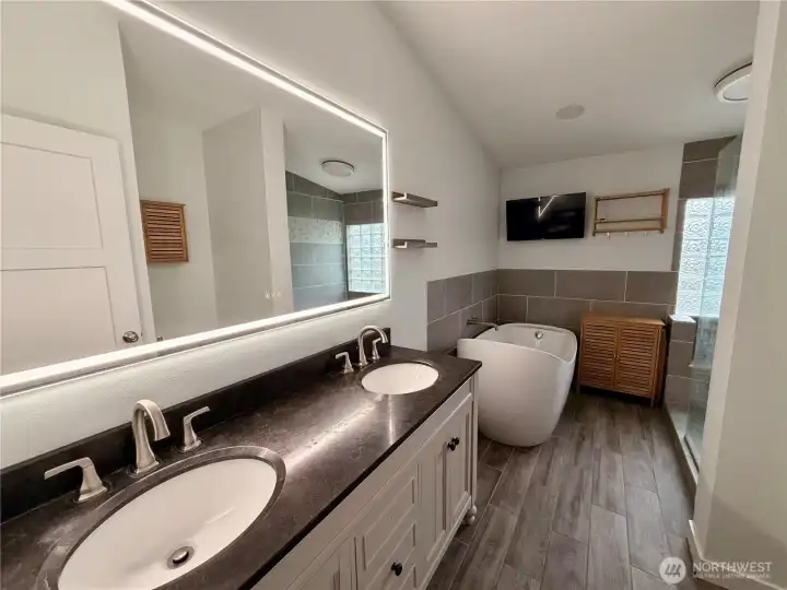 Beautiful en-suite bath with soaking tub, tv, and anti fog led mirror!