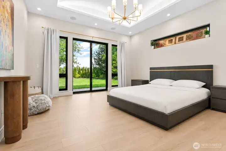 Light-filled primary bedroom designed for comfort and privacy, complete with patio access, custom details, and spa-inspired surroundings.