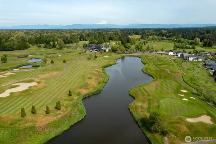 Premier golf course setting overlooking manicured fairways, water features, and peekaboo Mount Baker views on clear days.