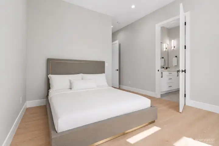 Bright secondary bedroom offering a functional layout, dedicated closet storage, and access to a shared full bath with the neighboring bedroom.