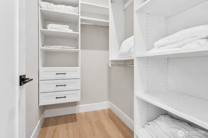 Walk-In Closet    Generous walk-in closet thoughtfully designed with custom built-in shelving, drawer storage, and dedicated hanging space. Offering exceptional organization and functionality, this well-appointed closet provides ample room for clothing, accessories, and everyday essentials while complementing the comfort and convenience of the secondary bedroom suite.