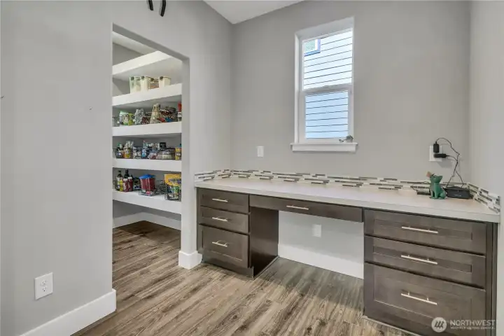 Large walk-in pantry to the left; door removed per seller preference. Door is stored in the garage for buyers who wish to reinstall. Built-in drop zone; garage access is to the right. Large walk-in pantry to the left; door removed per seller preference. Door is stored in the garage for buyers who wish to reinstall. Built-in drop zone; garage access is to the right.