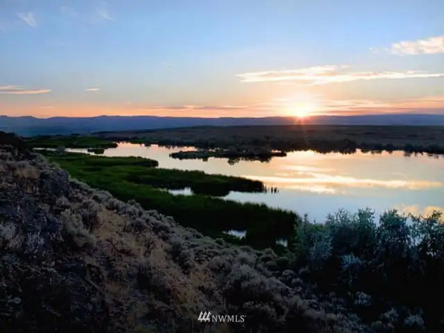 Beautiful vistas.  Sun setting in the West.  Mountain ridges ideal for home-sites. Additional sites around the lake provide dramatic vistas for additional home-sites.  Hilltop Lake below with island in middle.