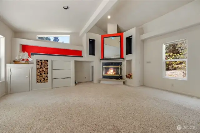 Wood burning fireplace, with a door to the exterior to pass wood through.