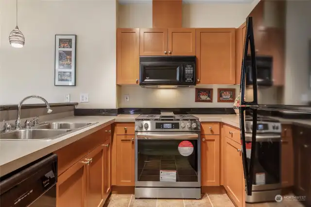 Timeless kitchen, deep double sink, black and stainless appliances with a brand new gas stove and oven!