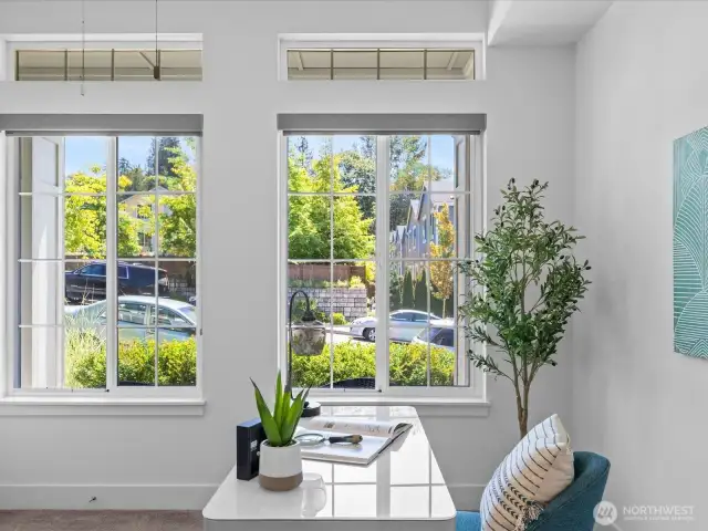 With bright windows, custom blinds & view of the neighborhood!