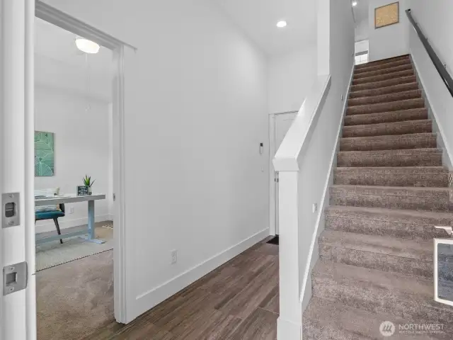 Hallway to 2-car garage & stairs to 2nd floor.