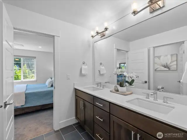 Separate room with double vanities, private commode.