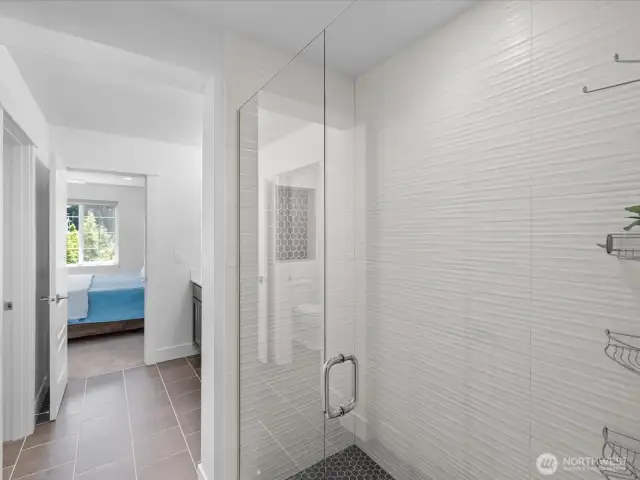 Upgrades include this stunning shower tile with inset!